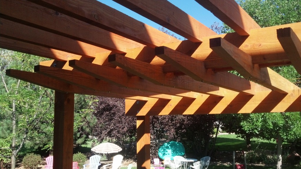 A stepped pergola detail creates elegant shadow lines.